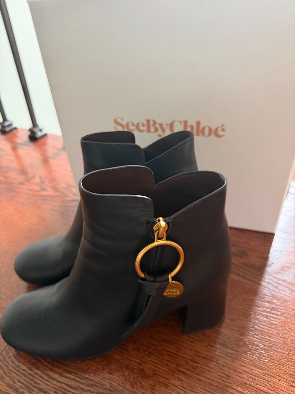 See By Chloé Black Leather Ankle Booties with Gold Ring Charm